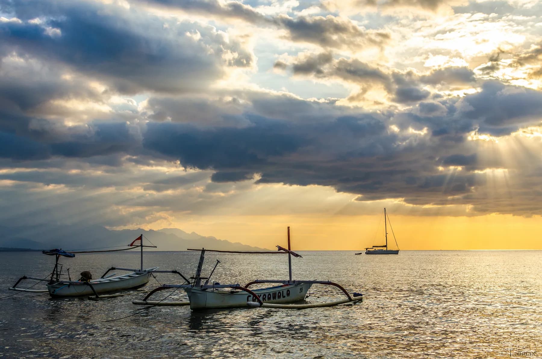 Traditional jukung boats at sunset, in Lovina, Bali